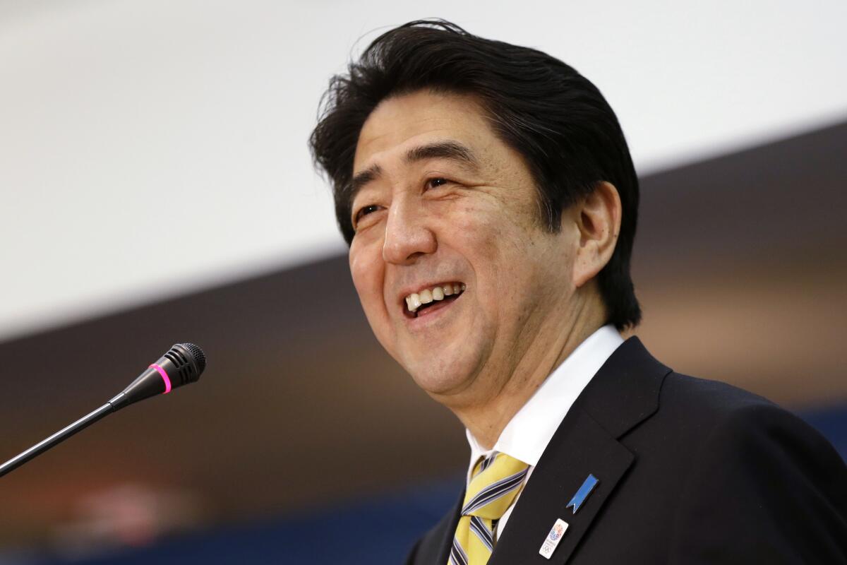 FILE - Japanese Prime Minister Shinzo Abe laughs while speaking at the Center for Strategic International Studies in Washington on Feb. 22, 2013. The assassination of former Japanese Prime Shinzo Abe has unearthed long-suspected, little-talked-of links between him and a religious group that started in South Korea but has spread its influence around the world. (AP Photo/Jacquelyn Martin, File)