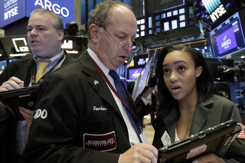 Trader Gordon Charlop, center, confers with colleague Lauren Simmons on the floor of the New York Stock Exchange, Monday, May 7, 2018. U.S. stocks moved broadly higher in early trading Monday, adding to solid gains at the end of last week. (AP Photo/Richard Drew)