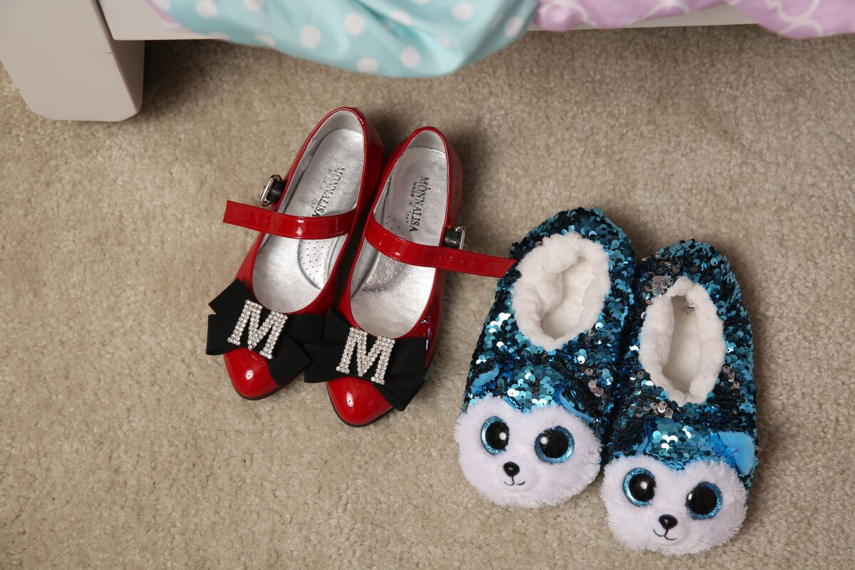 Slippers and shoes sit by Mykal-Michelle Harris' bed.