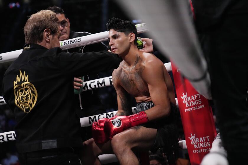 Ryan Garcia sits in his corner between rounds during a lightweight boxing bout against Gervonta Davis, Saturday, April 22, 2023, in Las Vegas. (AP Photo/John Locher)