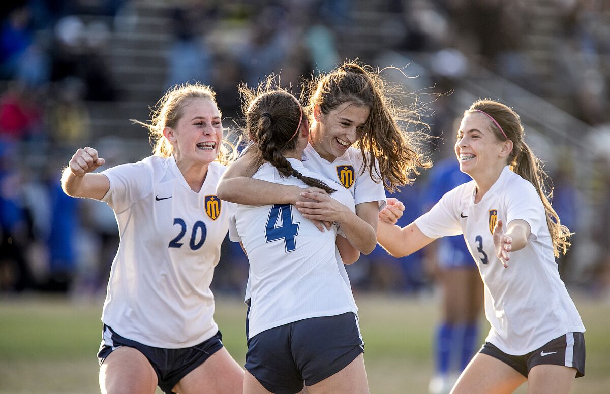 Marina’s Samantha Esparza (20), Izzie Krysinski (4) and Riley Crosby (3) celebrate with Isabella Moawad, center.