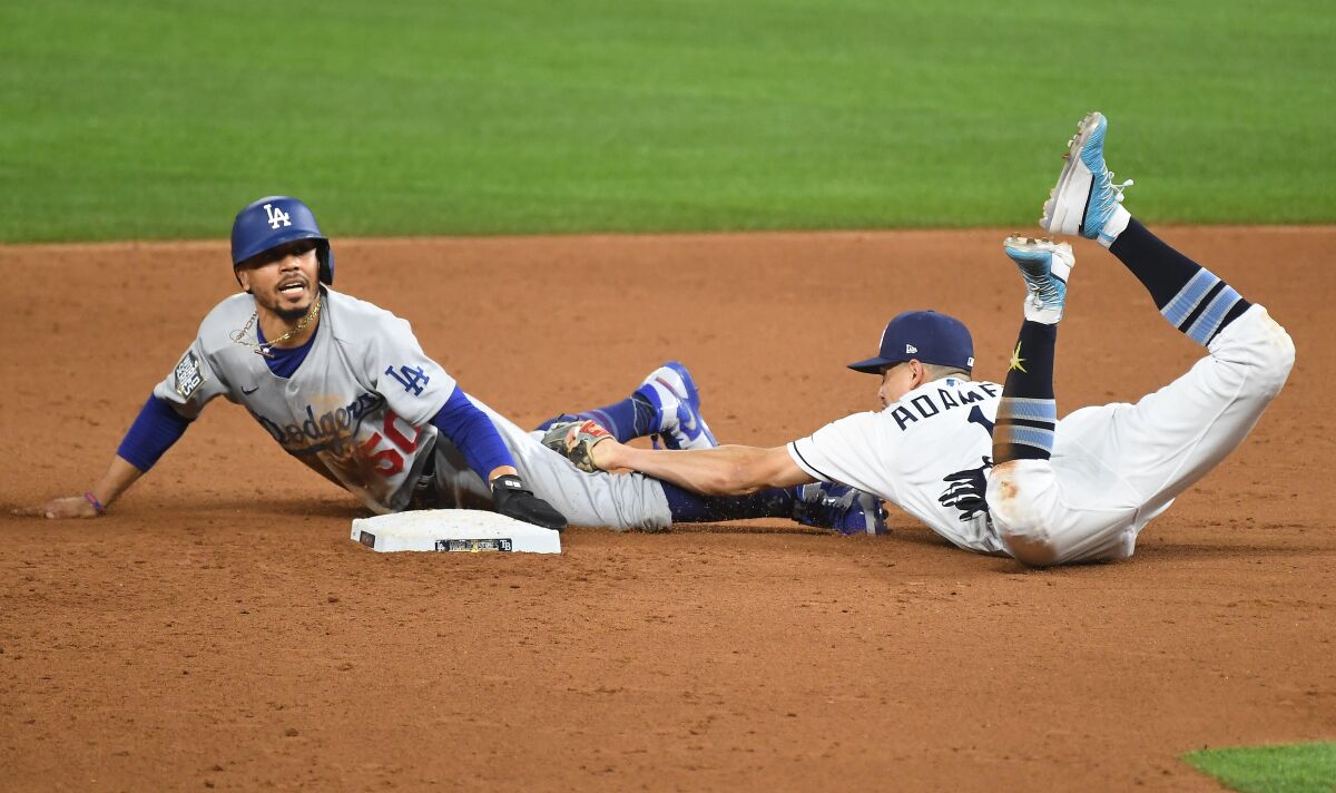 Dodgers Mookie Betts steals second base in front of Tampa Bay Rays shortstop Willy Adames.