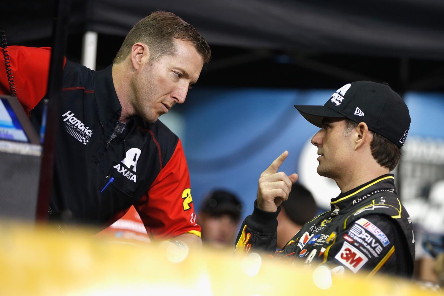 Jeff Gordon, driver of the #24 AXALTA Chevrolet, talks to crew chief Alan Gustafson during qualifying for the NASCAR Sprint Cup Series Ford EcoBoost 400 at Homestead-Miami Speedway on November 20, 2015 in Homestead, Florida.