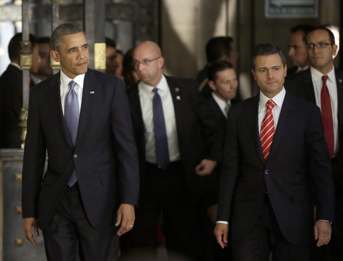 President Obama, left, and Mexican President Enrique Peña Nieto, right, arrive for a news conference at the National Palace in Mexico City.
