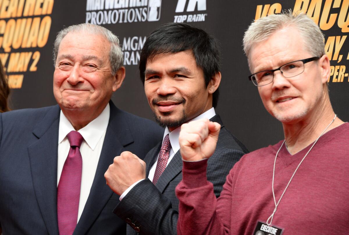 Promotor Bob Arum, boxer Manny Pacquiao and trainer Freddie Roach arrive for a joint news conference with Floyd Mayweather Jr. on March 11 to promote Pacquiao and Mayweather's May 2 bout.
