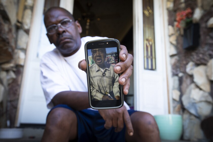 Daryl Kennedy, 57, holds a photo of his uncle, R.C. Kendrick.