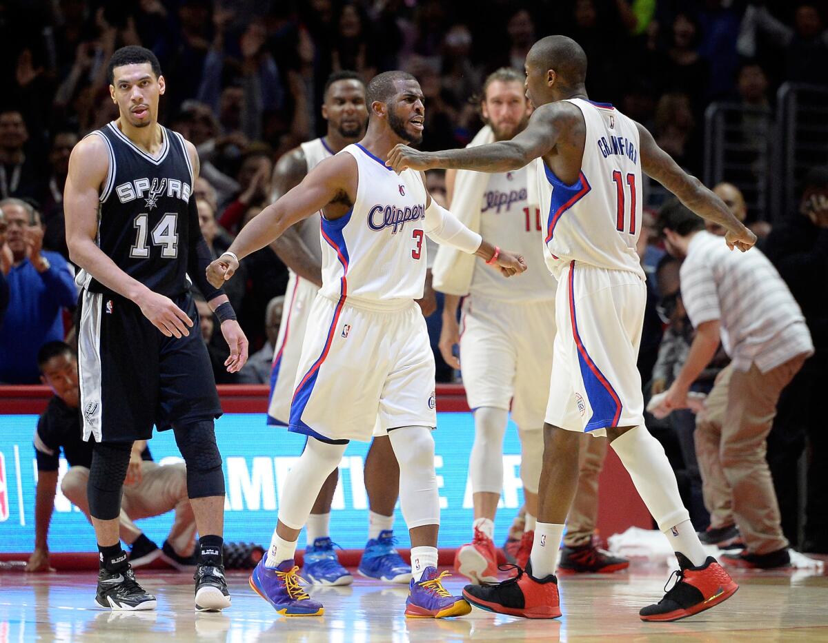 Jamal Crawford celebrates with Chris Paul after a three-point shot against San Antonio during the Clippers' 119-115 win Thursday over the Spurs at Staples Center.