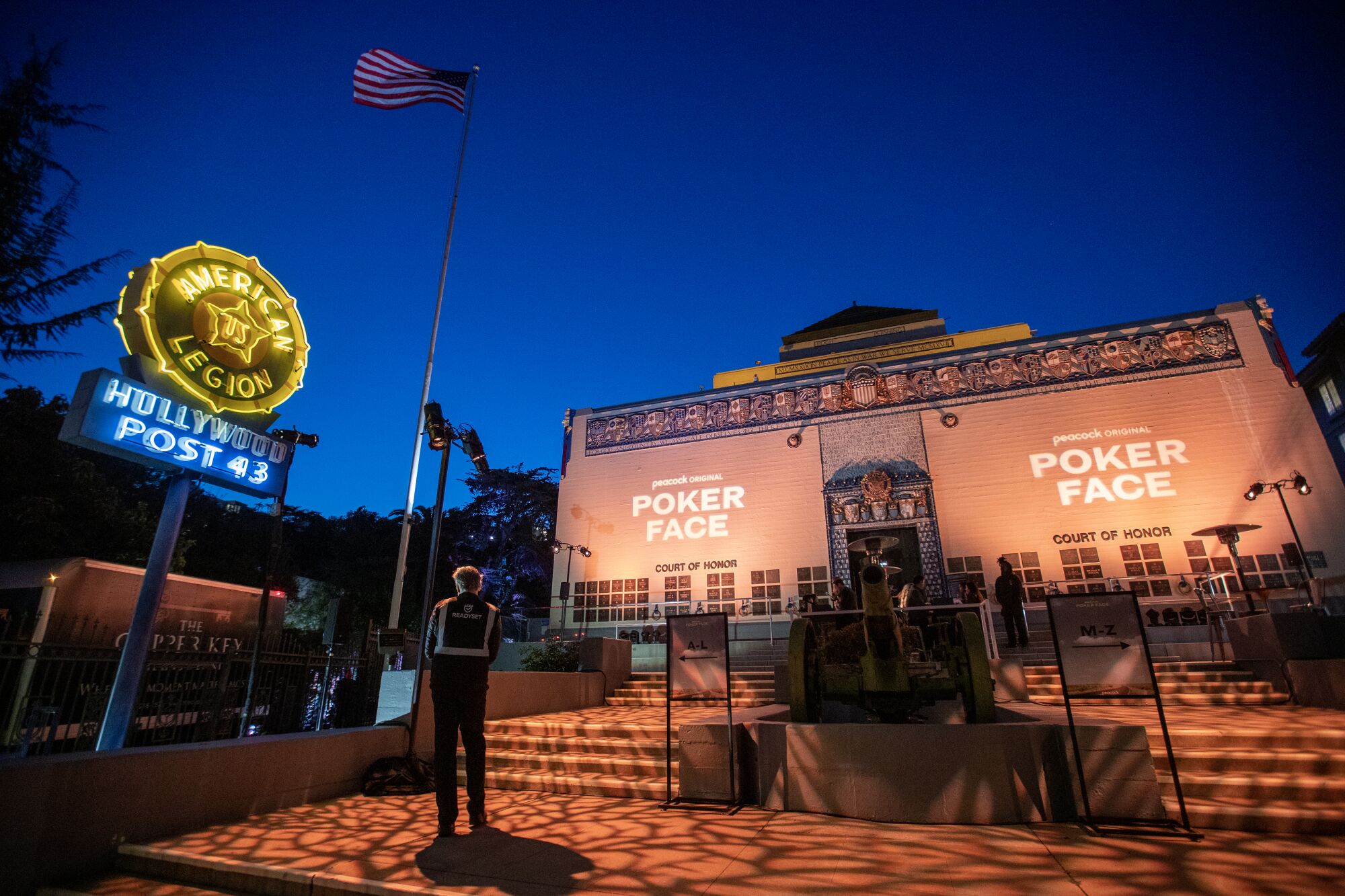 The words "Peacock presents Poker Face" are projected onto the exterior of the building