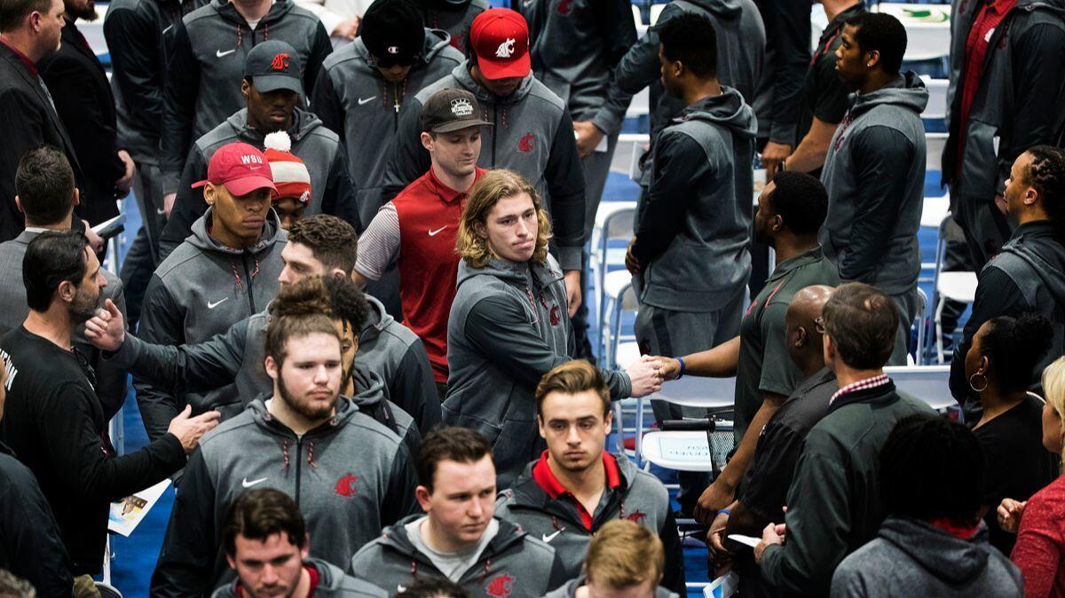 Washington State football players leave the gymnasium after the funeral for their teammate quarterback Tyler Hilinski at Damien High School on Saturday.