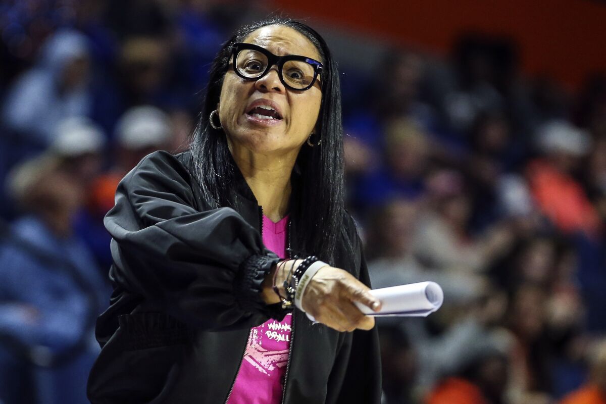 FILE - In this Feb. 27, 2020, file photo, South Carolina head coach Dawn Staley reacts to an official's call during the second half of an NCAA college basketball game against Florida in Gainesville, Fla. Dawn Staley and South Carolina have agreed to a new, seven-year contract that will pay her $2.9 million this season and grow to $3.5 million in the final season. The school's Board of Trustees approved the deal worth $22.4 million on Friday, Oct. 15, 2021, to keep the national championship coach with the Gamecocks through the 2027-28 season. (AP Photo/Gary McCullough, File)