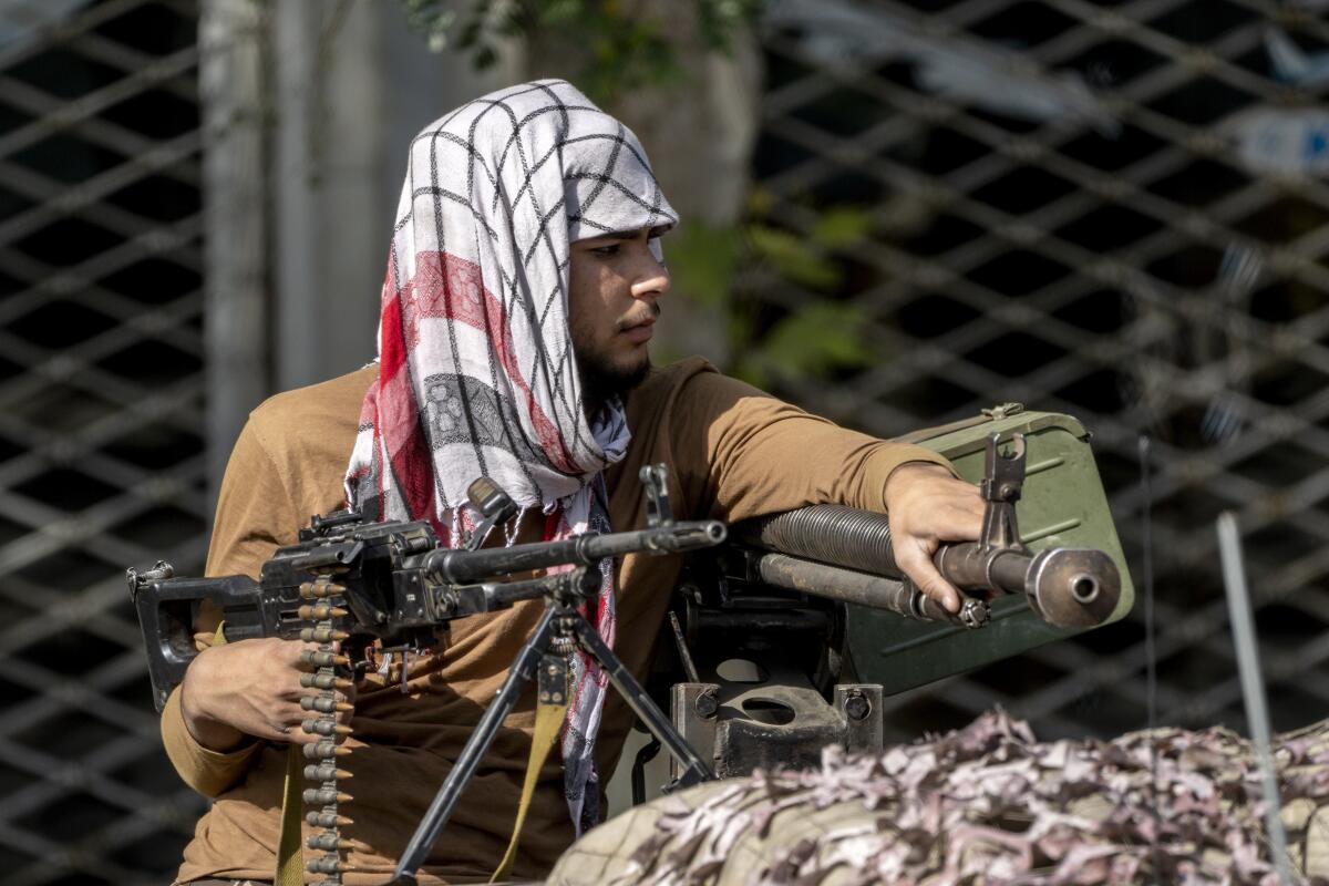 A Taliban fighter holds a gun.