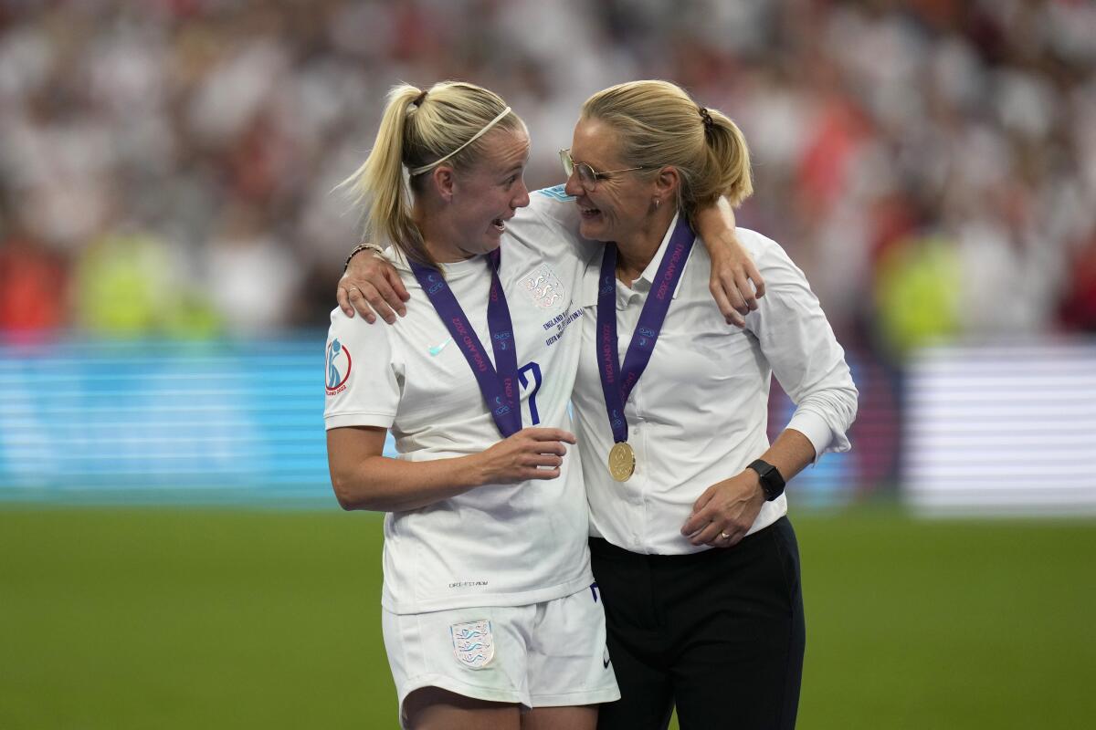 England's Beth Mead celebrates with England's manager Sarina Wiegman after winning the Women's Euro 2022 final soccer match between England and Germany at Wembley stadium in London, Sunday, July 31, 2022. England won 2-1. (AP Photo/Alessandra Tarantino)