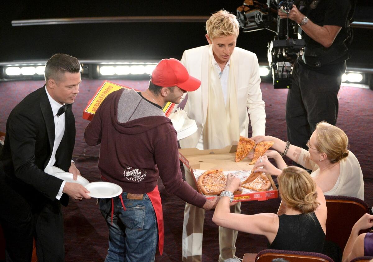 Host Ellen DeGeneres hands out pizza during the Oscars. The pizza delivery and her A-list selfie helped the telecast soar on Twitter.