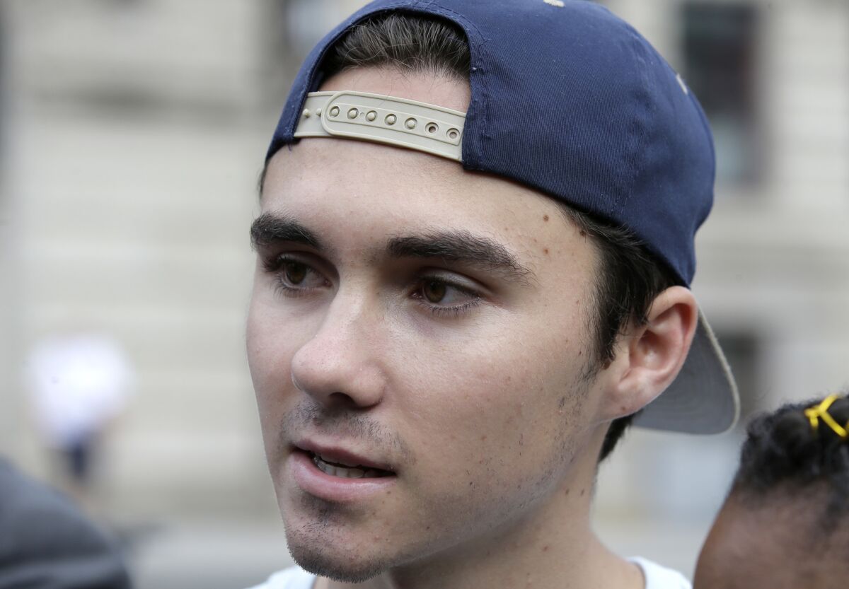 David Hogg speaks with reporters before a 2018 march in Worcester, Mass.