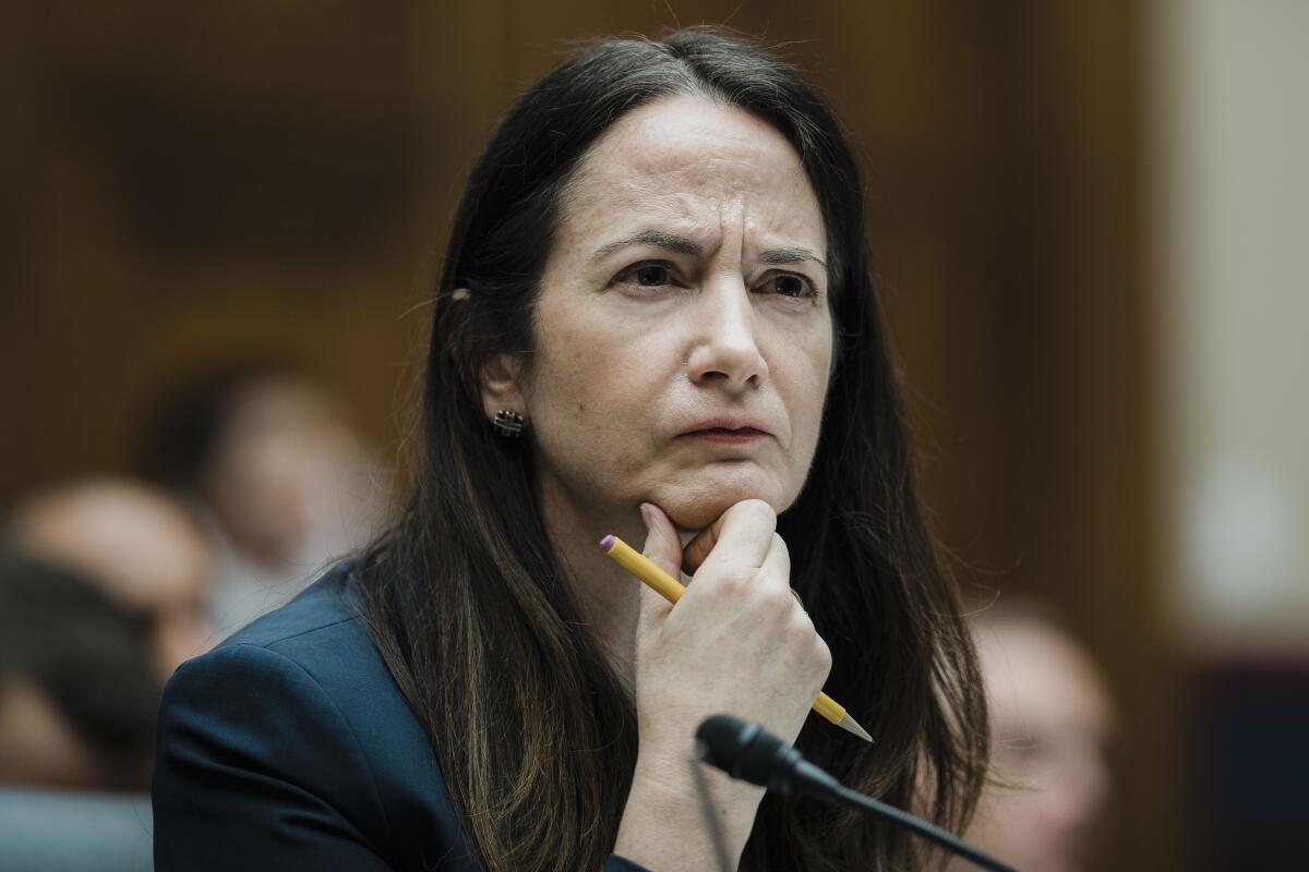 A woman listens during a hearing.