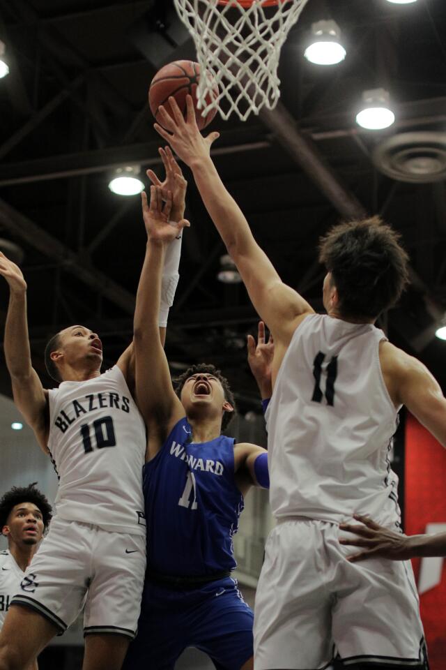 Windward's Devin Tillis drives to the basket against Sierra Canyon's Amari Bailey and Harold Yu.