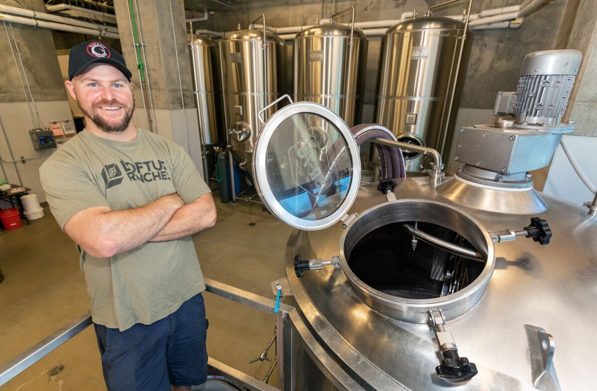 Matt Dale, the master brewer at the Rincon Reservation Road Brewery, is pictured next to a brewing vat. 