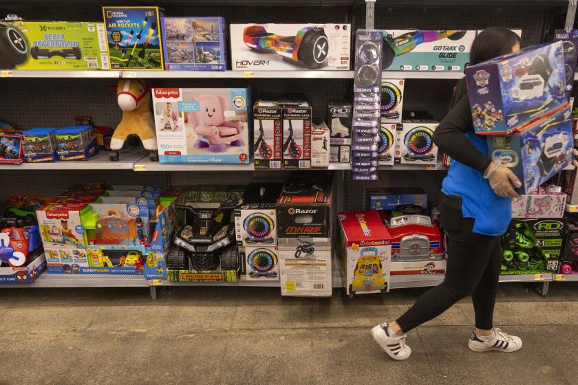 Burbank, CA - November 14: An employee stocks toy department shelves as Black Friday deals are out and prices are being rolled back at the Walmart Supercenter on Tuesday, Nov. 14, 2023 in Burbank, CA. (Brian van der Brug / Los Angeles Times)