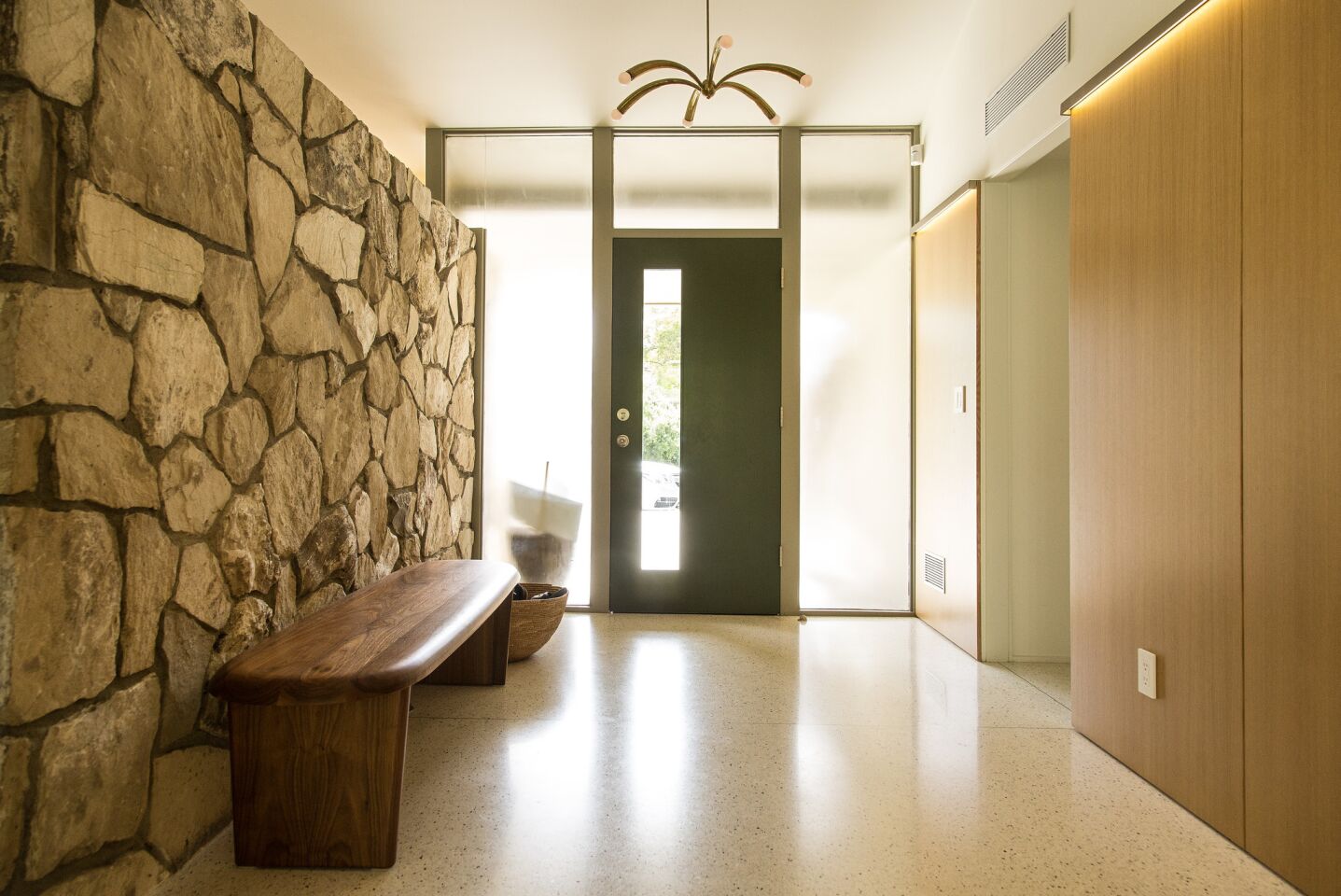 Poured-in-place white terrazzo flooring brightens the entry and corridor.