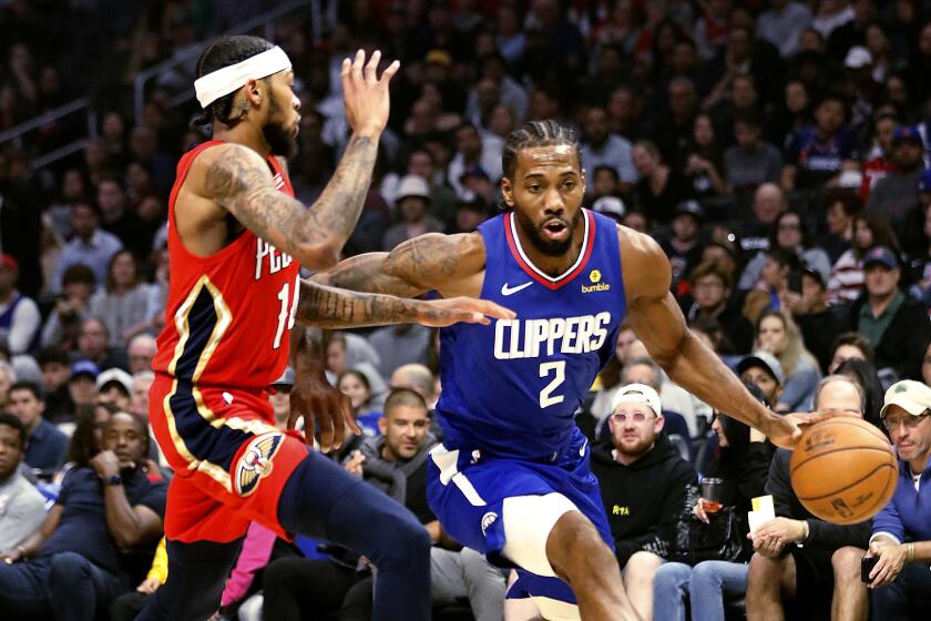 LOS ANGELES, CALIF. - NOV. 24, 2019. Clippers forward Kawhi Leonard drives to the basket against Pelicans forward Brandon Ingraham in the second quarter at Staples Center in Los Angeles on Sunday night, Nov. 24, 2019. (Luis Sinco/Los Angeles Times)