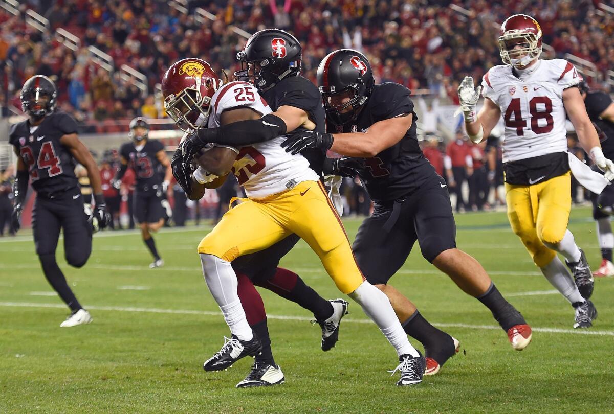 USC's Ronald Jones II scores a touchdown, dragging Stanford's Dallas Lloyd (29) into the endzone during the third quarter of the Pac-12 Championship game at Levi's Stadium on Saturday.