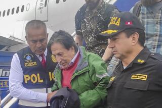 Officers escort former President Alejandro Toledo upon his arrival from the United States to the airport in Lima.