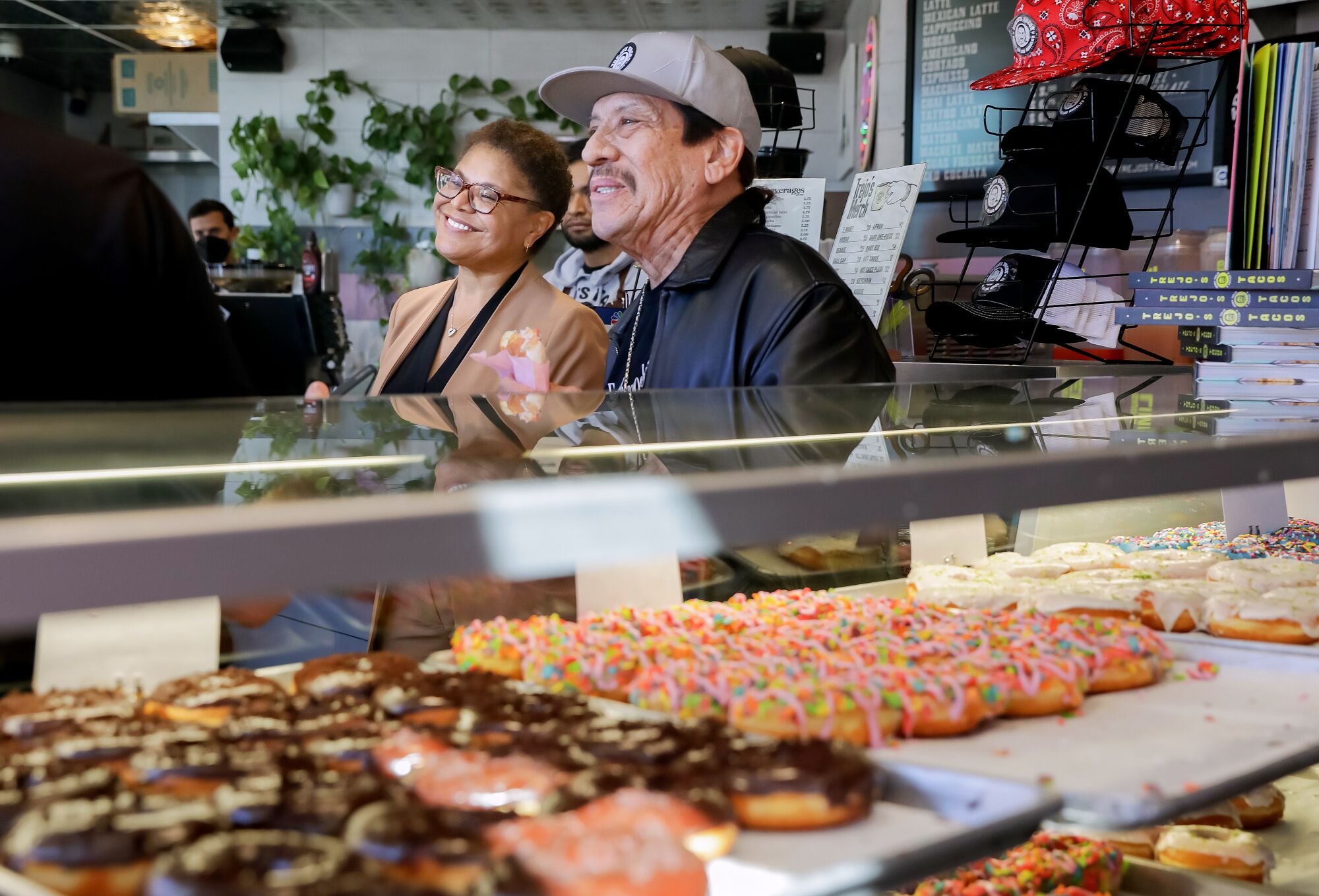 L.A. Mayoral candidate Karen Bass, left, meets with actor Danny Trejo, right, at Trejo's Coffee and Donuts