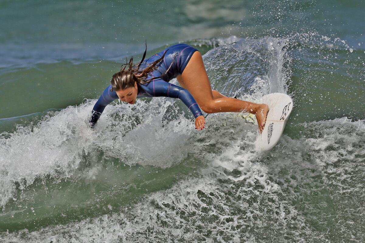 A surfer last Memorial Day weekend at Manhattan Beach. In a Travelocity poll, L.A. ranked fourth as a destination for the holiday.