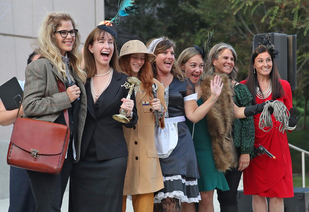 A group of ladies gather for first place picture during the Clue Character Costume Contest.
