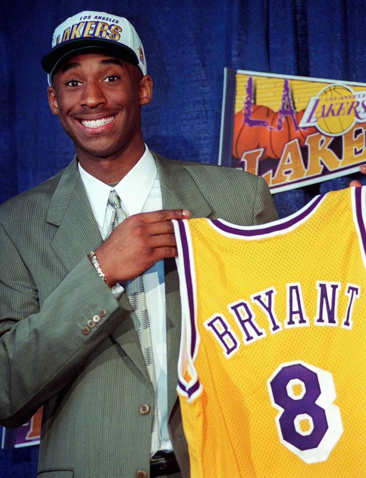 Kobe Bryant, at 17, holding his Lakers jersey.