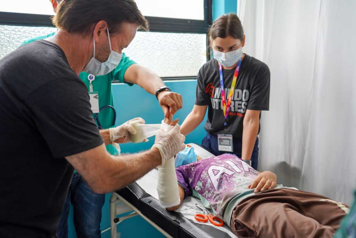 Dr. Timothy Ross, left, and Cassie Ross wrap a patient's arm during a mission trip to Ecuador in May 2022.