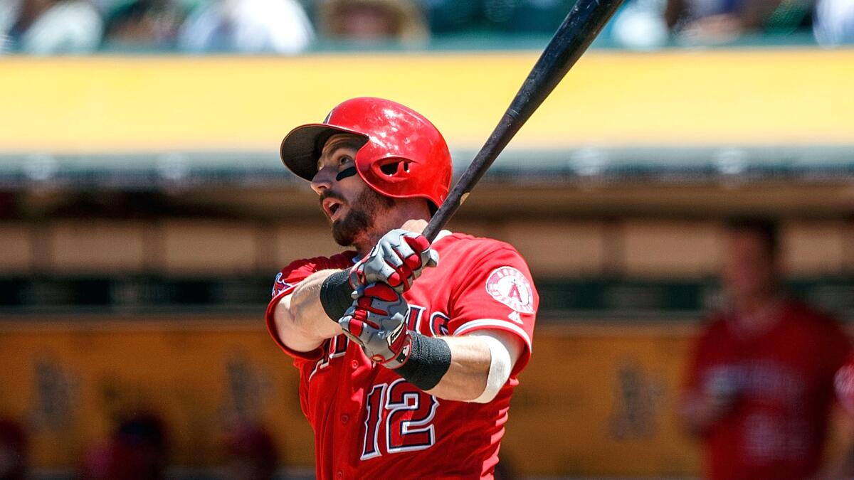 Angels second baseman Johnny Giavotella follows through on his home run swing against the Oakland Athletics in the fourth inning Saturday.
