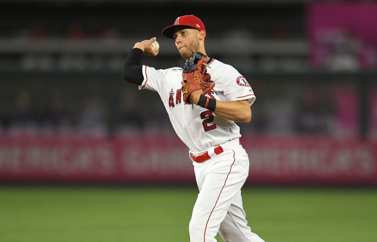 Angels shortstop Andrelton Simmons throws to first base.