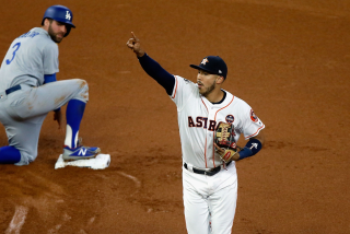 Astros shortstop Carlos Correa celebrates after after tagging out Dodger Chris Taylor