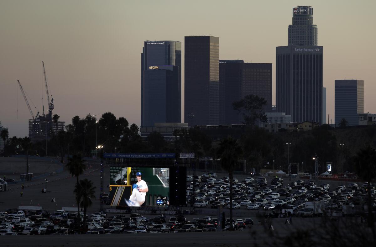 Fans drive into Dodger Stadium for a drive-in viewing party for the NLCS against the Atlanta Braves.