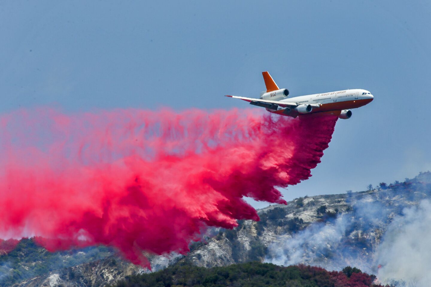 A DC-10 air tanker drops Phos-Chek, a fire retardant, on the Fish fire in Duarte on June 22.
