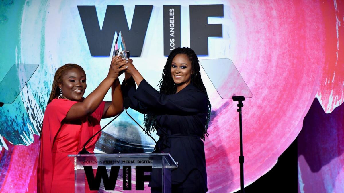 Honorees Denisia "Blu June" Andrews, left, and Brittany "Chi" Coney of NOVA Wav accept the Women In Film Artistic Excellence Award onstage during the organization's Crystal + Lucy Awards.