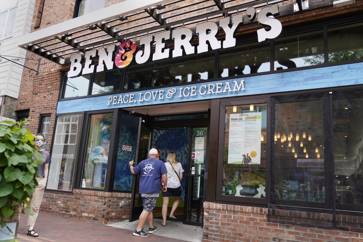 FILE - Two patrons enter a Ben & Jerry's Ice Cream shop, Tuesday, July 20, 2021, in Burlington, Vt. A federal judge on Monday, Aug. 22, 2022, rejected a request by Ben & Jerry’s to block a plan by its corporate parent to allow its products to be sold in east Jerusalem and the occupied West Bank against the wishes of the Vermont ice cream maker's independent board of directors. (AP Photo/Charles Krupa, File)