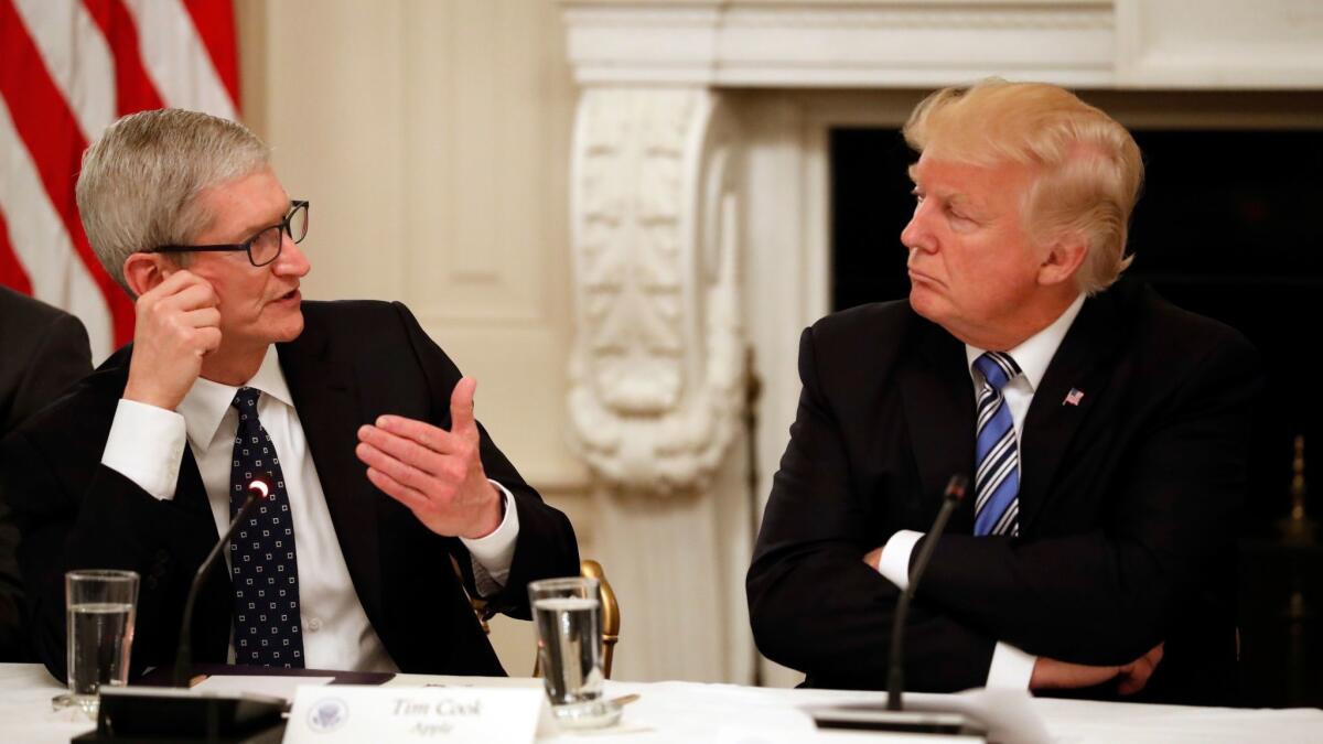 Apple Chief Executive Tim Cook speaks to President Trump at an American Technology Council roundtable at the White House last month.