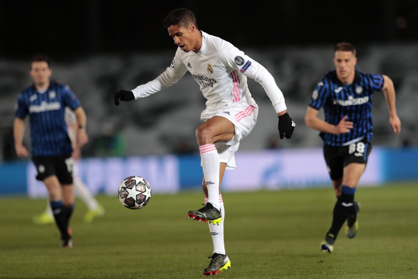 Real Madrid's Raphael Varane controls the ball during the Champions League, round of 16, second leg soccer match between Atalanta and Real Madrid at the Alfredo di Stefano stadium in Madrid, Spain, Tuesday, March 16, 2021. (AP Photo/Bernat Armangue)
