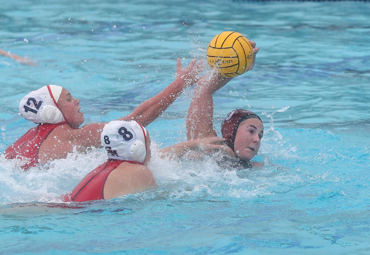 Laguna Beach attacker Lauren Short (10) pulls away from two San Marcos defenders for a shot attempt on Friday.