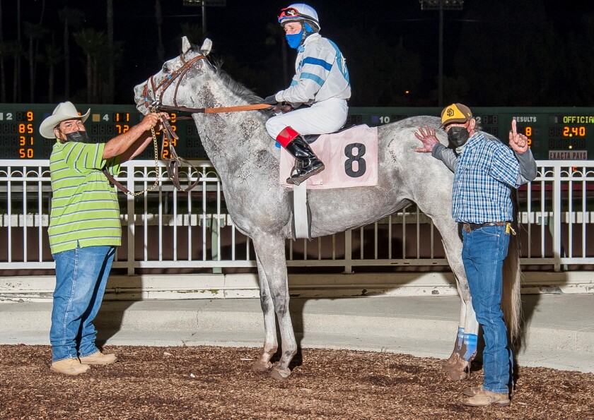 Trainer Joe Herrick, right, with Lovely Finish after the filly's first career win Saturday at Los Alamitos.