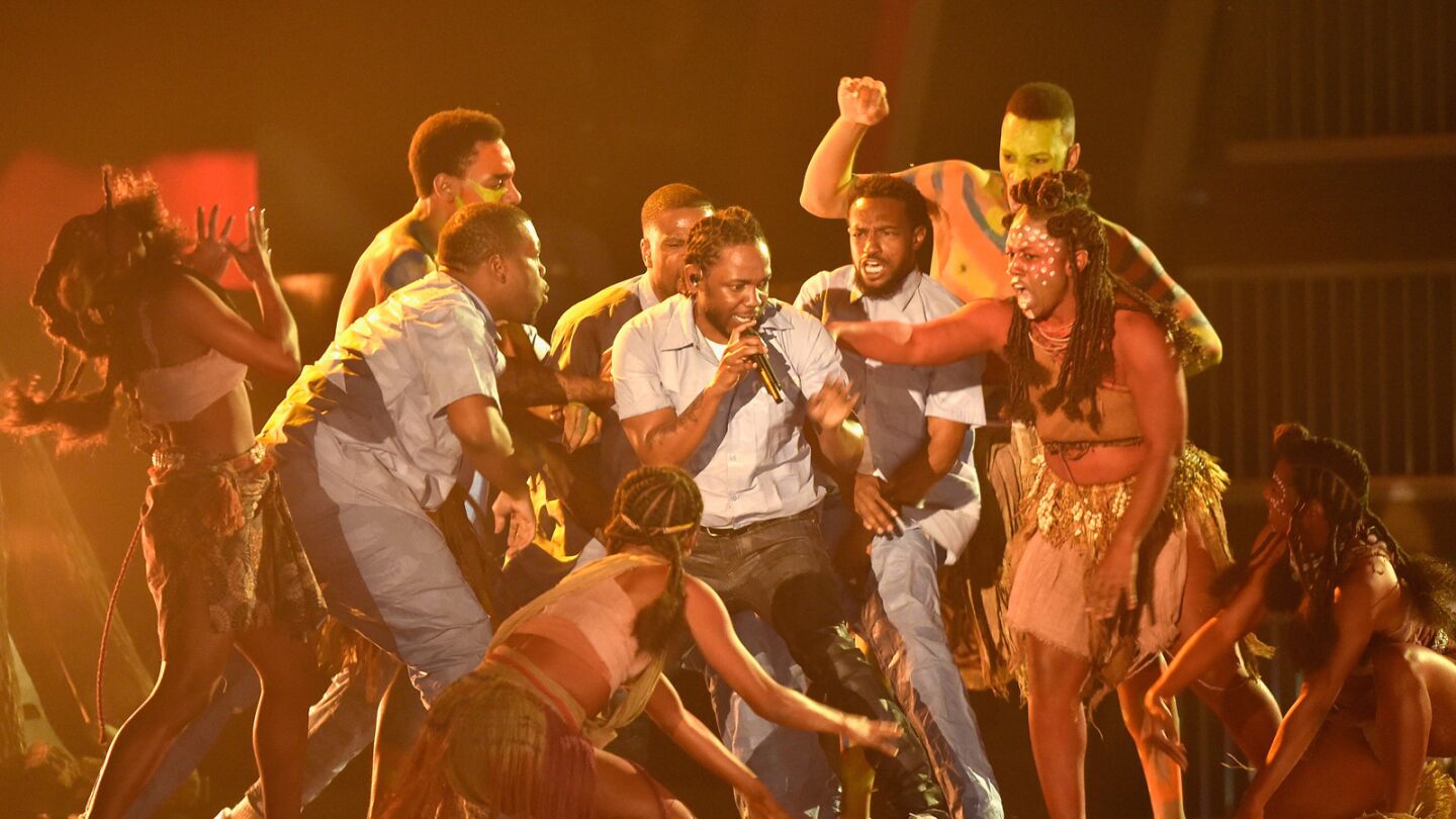 Rapper Kendrick Lamar, center, performs a rendition of his songs "The Blacker the Berry" and "Alright."