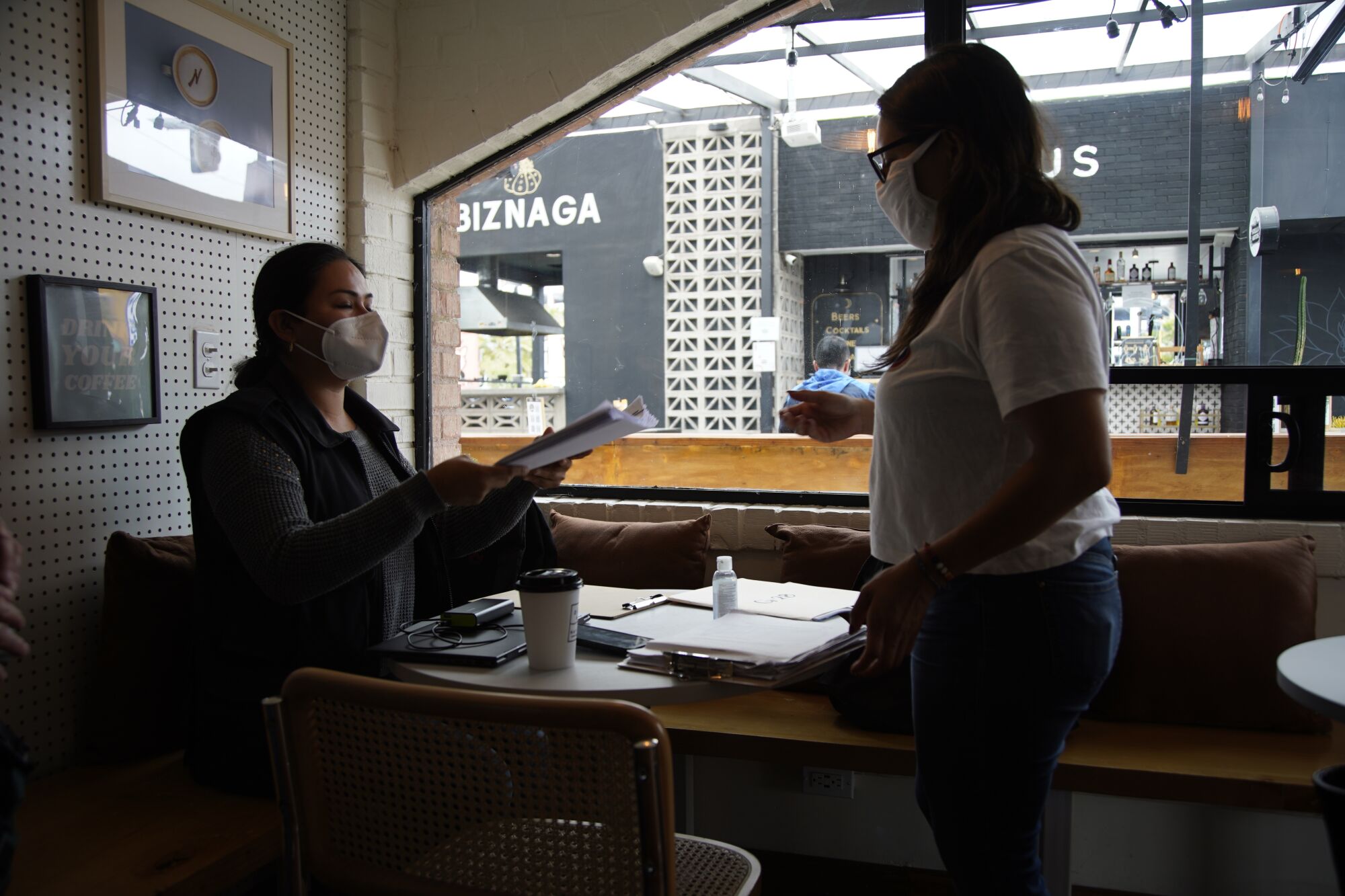 Dulce Garcia receives legal documents at a coffee shop near the Tijuana-San Diego border