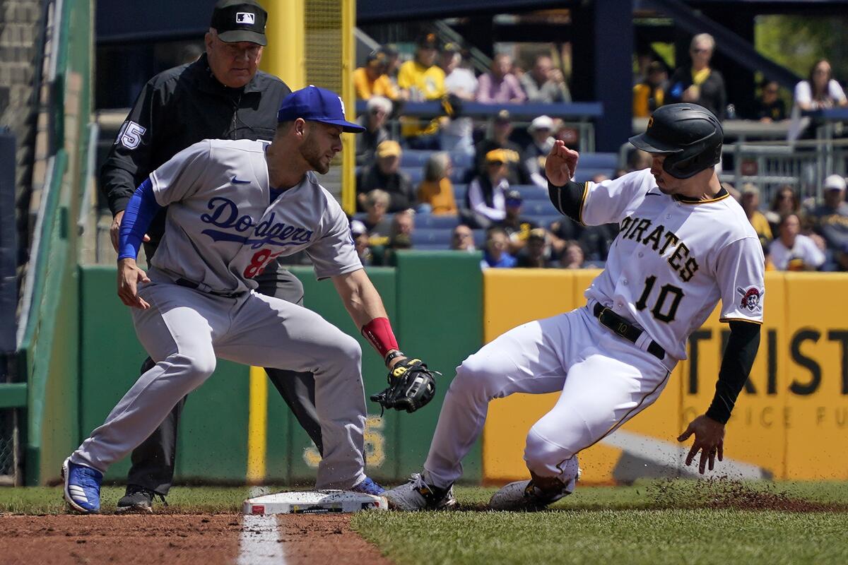 Dodgers third baseman Michael Busch leans forward to try to make a tag during a game 