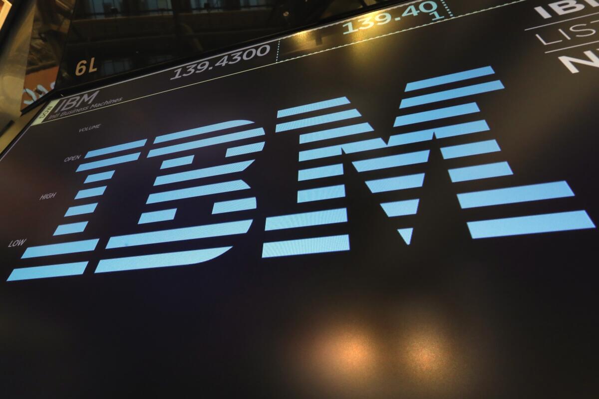 The IBM logo appears above a trading post on the floor of the New York Stock Exchange.