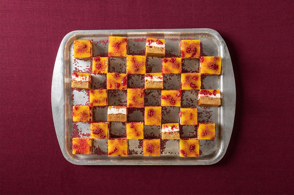 Square cookies in a checkerboard pattern on a metal tray.