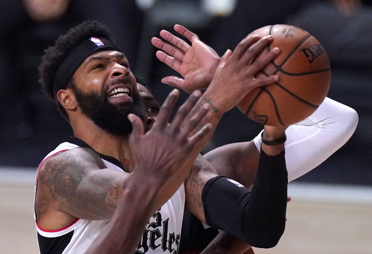 Clippers forward Marcus Morris Sr. powers his way to the basket for a shot during the playoffs last season.