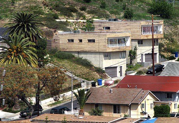 Lincoln Heights dates to the 1880s and is one of Los Angeles' first neighborhoods outside downtown. But here, carved into a bluff, sit twin houses that look like 21st century refugees from a modern architecture magazine. Sleek and boxy, with the top floor sheathed in unpainted cedar siding, the contemporary designs were built by Hardy and Kevin Wronske of the Los Angeles-based Heyday Partnership.