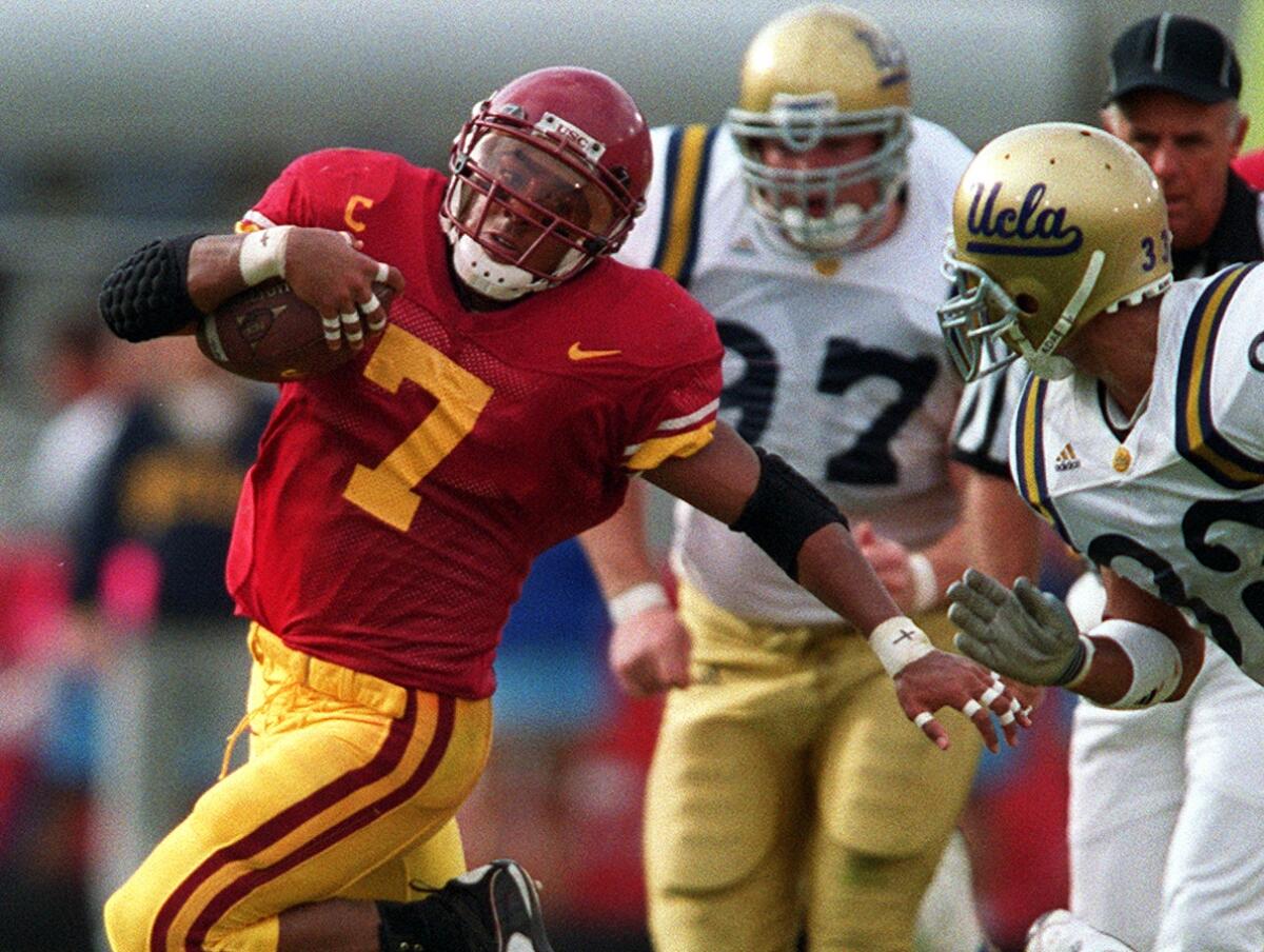 USC tailback Chad Morton eludes the grasp of a UCLA defender during the Trojans' 17-7 victory at the Coliseum on Nov. 20, 1999.